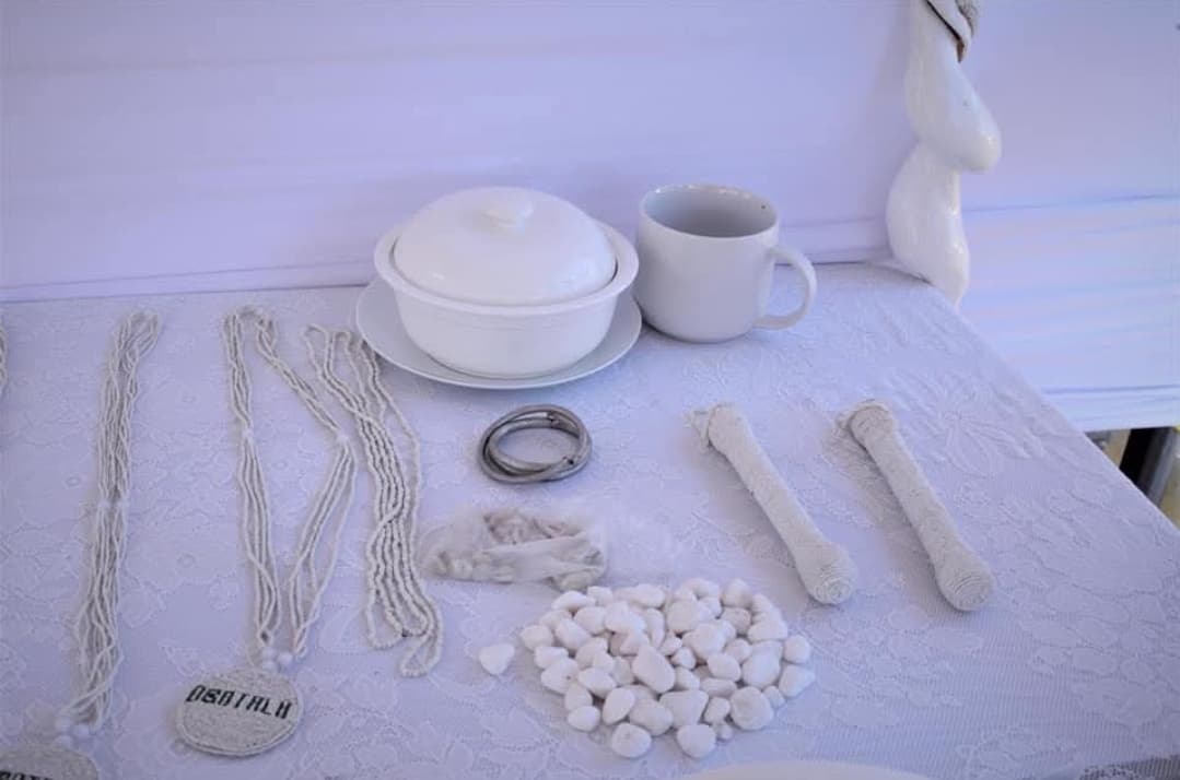 Sacred Obatala items including white eleke beads, ceremonial vessels, and sacred objects
